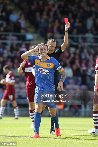 Liam Lawrence of Shrewsbury Town is shown a red card by referee Darren Deadman during the Sky Bet League Two match between Northampton Town and...