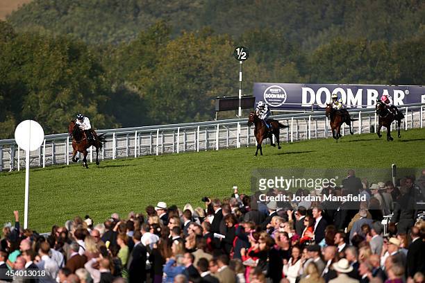 Shane Kelly riding Tall Ship comes in to win the Chichester Observer Stakes in front of Harry Bentley riding Artful Rogue at Goodwood racecourse on...