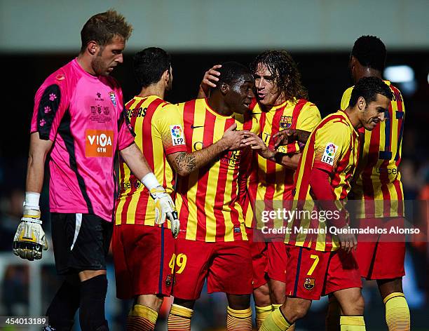 Dongou of Barcelona celebrates with his teammate Carles Puyol during the Copa del Rey Round of 32 match between FC Cartagena and FC Barcelona at...