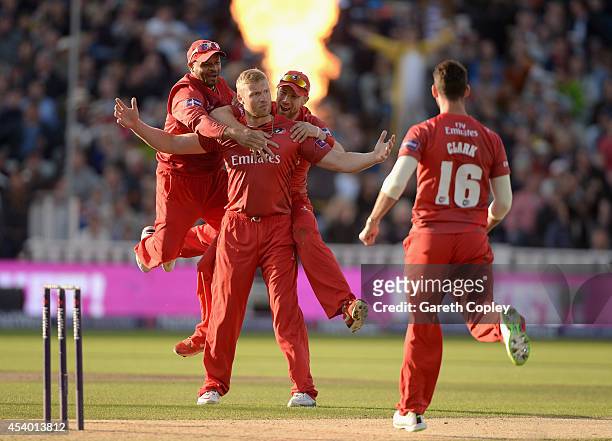 Andrew Flintoff of Lancashire celebrates with Ashwell Prince and Paul Horton after dismissing Ian Bell of Birmingham Bears during the Natwest T20...