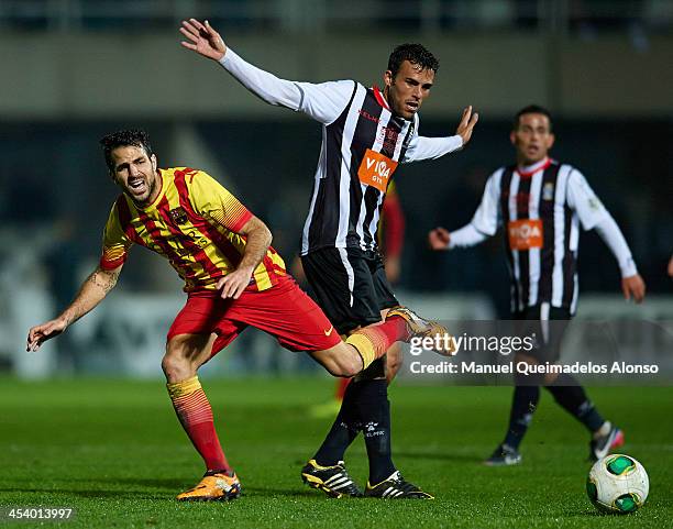 Carlos David of Cartagena competes for the ball with Cesc Fabregas of Barcelona during the Copa del Rey, Round of 32 match between FC Cartagena and...