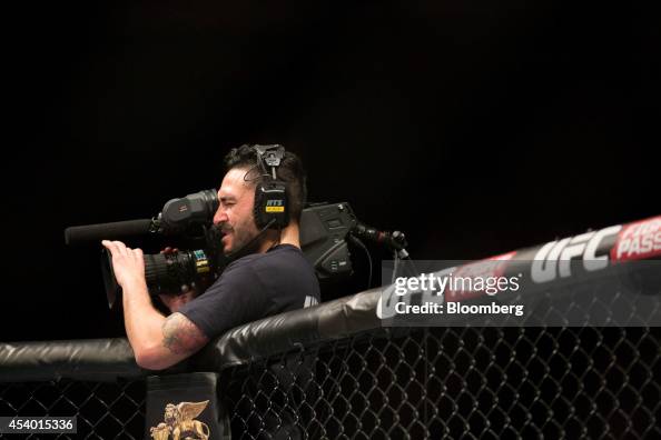 Ufc Camera A cameraman films fighters in the octagon during Ultimate Fighting ...