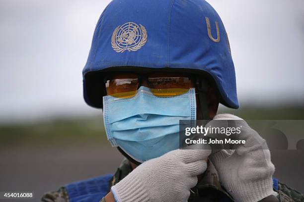 Chinese UN soldier prepares a truckload of Ebola relief aid after it was airlifted by the United Nations Children's Fund , on August 23, 2014 in...