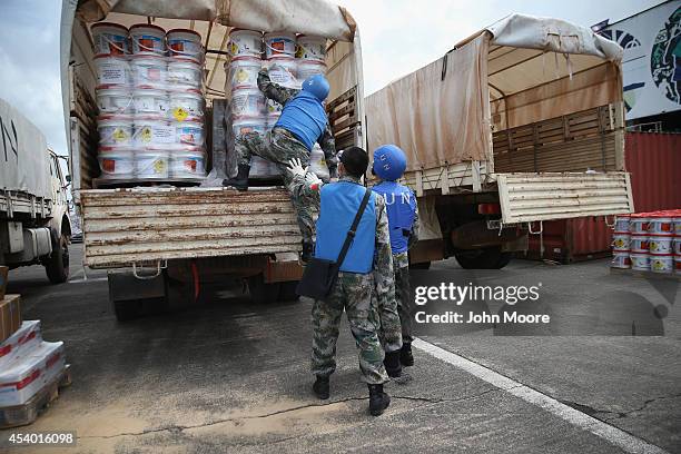 Chinese UN soldiers prepare truckloads of Ebola relief aid after it was airlifted by the United Nations Children's Fund , on August 23, 2014 in...