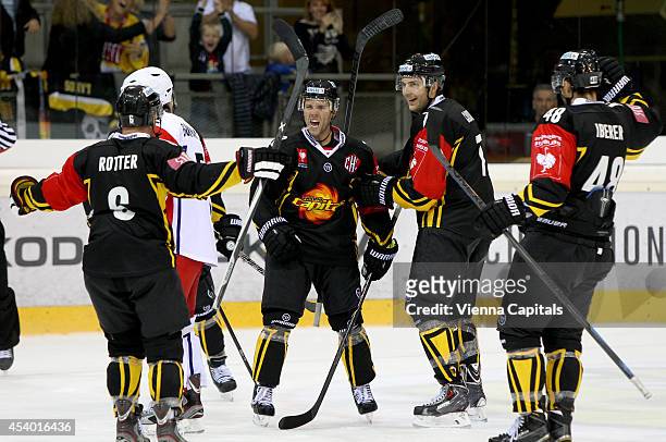 Rafael Rotter, Peter MacArthur, Brett Carson and Florian Iberer of Capitals celebrate during the Champions Hockey League group stage game between EV...