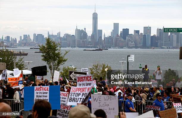The Manhattan skyline is seen as people march during rally against police violence on August 23, 2014 in the borough of Staten Island in New York...