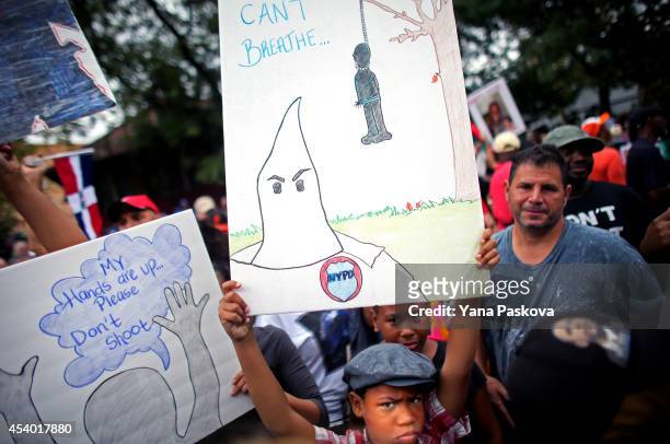 People attend a rally against police violence on August 23, 2014 in the Staten Island borough of New York City. Thousands of marchers are expected...