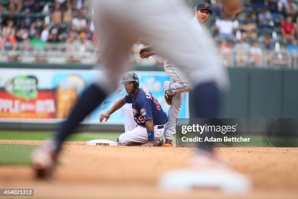 Danny Santana of the Minnesota Twins looks back at first after being tagged out by Ian Kinsler of the Detroit Tigers in the fifth inning at Target...