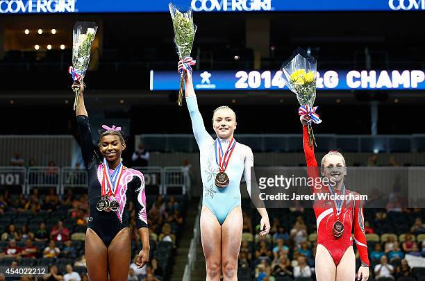 Jazmyn Foberg , Nia Dennis , and Norah Flatley , stand on the winners podium following the junior women finals during the 2014 P&G Gymnastics...
