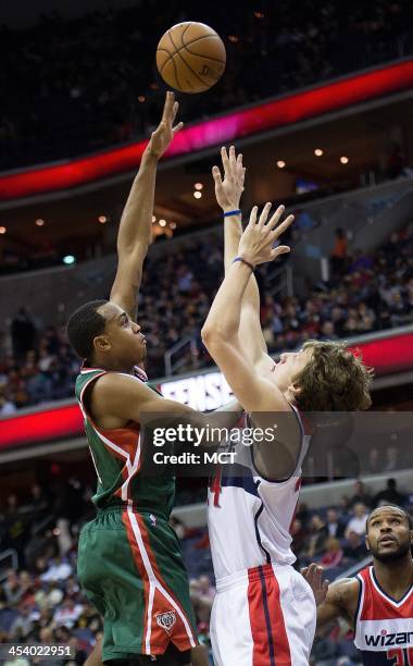 Milwaukee Bucks power forward John Henson shoots over Washington Wizards power forward Jan Vesely during the first half of their game played at the...