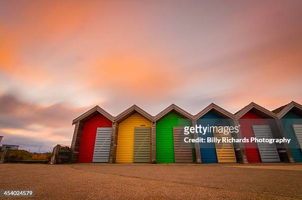 vivid coloured beach huts at sunset - tyne and wear stock pictures, royalty-free photos & images