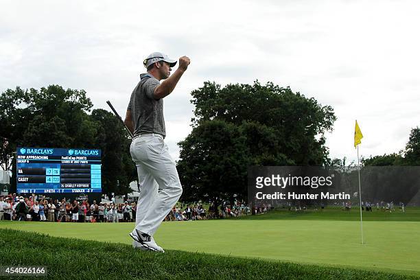 Paul Casey of England reacts after chipping in for birdie on the 18th green during the third round of The Barclays at The Ridgewood Country Club on...
