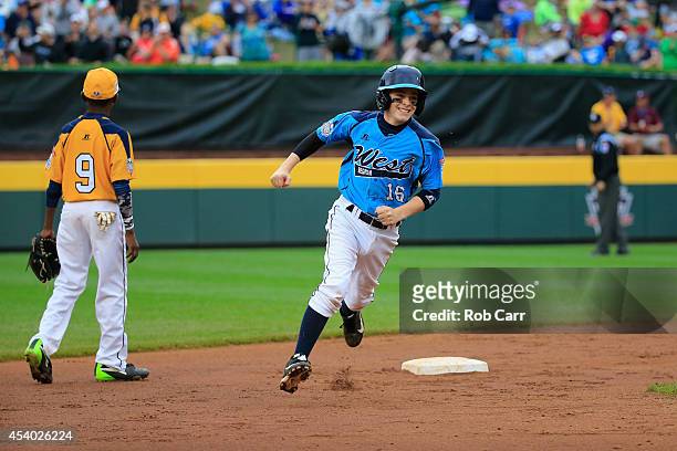Brad Stone of the West Team from Las Vegas, Nevada rounds the bases after hitting a home run against the Great Lakes Team from Chicago, Illinois...