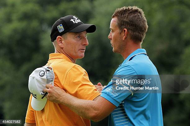 Jim Furyk shakes hands with Henrik Stenson of Sweden after they finished on the 18th green during the third round of The Barclays at The Ridgewood...