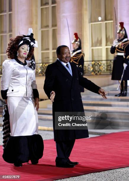 Cameroun's President Paul Biya and his wife Chantal arrive for a diner at the Elysee presidential palace in Paris, as part of the Elysee summit for...