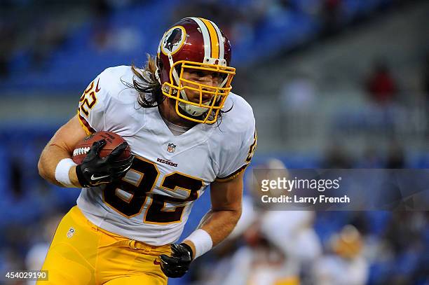 Tight end Logan Paulsen of the Washington Redskins warms up before a preseason game against the Baltimore Ravens at M&T Bank Stadium on August 23,...