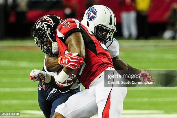 Bernard Pollard of the Tennessee Titans tackles Antone Smith of the Atlanta Falcons on a run in the first half of a preseason at the Georgia Dome on...