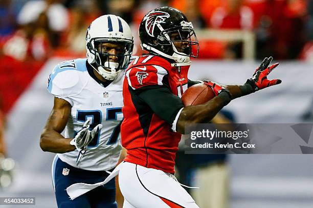 Devin Hester of the Atlanta Falcons runs past Tommie Campbell of the Tennessee Titans after a catch to score a touchdown in the first half of a...