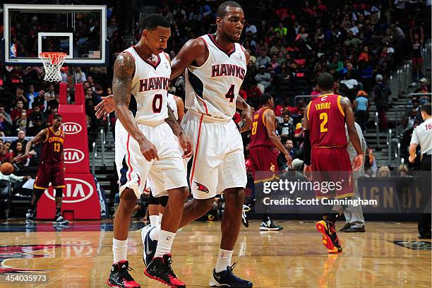 Jeff Teague and Paul Millsap of the Atlanta Hawks walk off the court during the game against the Cleveland Cavaliers on December 6, 2013 at Philips...
