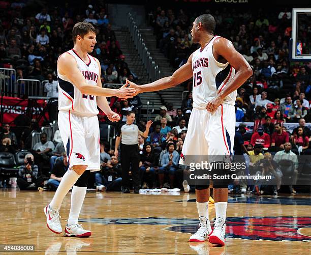 Kyle Korver and Al Horford of the Atlanta Hawks shake hands against the Cleveland Cavaliers on December 6, 2013 at Philips Arena in Atlanta, Georgia....