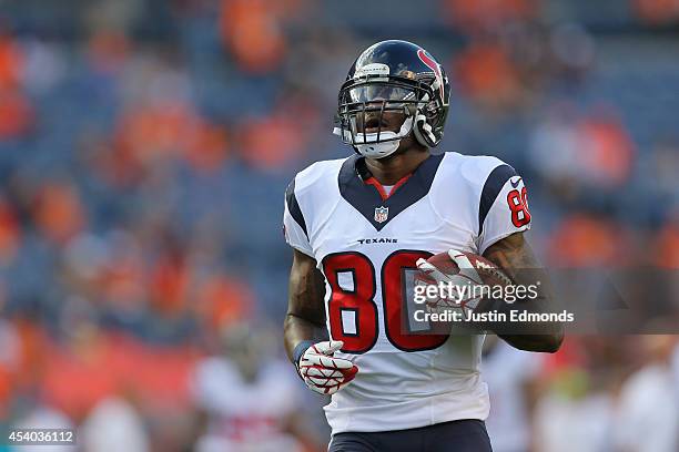 Wide receiver Andre Johnson of the Houston Texans warms up before a preseason game against the Denver Broncos at Sports Authority Field at Mile High...