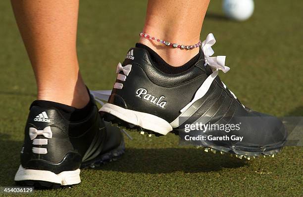 View of Paula Creamer of the USA's shoes as she putts on the practice green, in her monogrammed Adidas golf shoes, ahead of the tournament, on day...