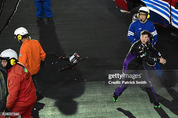 Denny Hamlin, driver of the FedEx Ground Toyota, throws his hans device at Kevin Harvick , driver of the Jimmy John's Chevrolet, after an on-track...