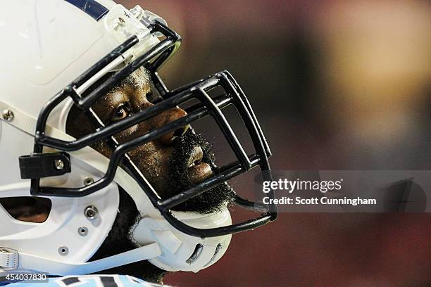 Michael Oher of the Tennessee Titans is seen on the sidelines in the first half of a preseason game against the Atlanta Falcons at the Georgia Dome...