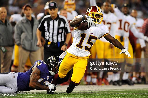 Wide receiver Aldrick Robinson of the Washington Redskins is brought down by defensive back Dominique Franks of the Baltimore Ravens during a...