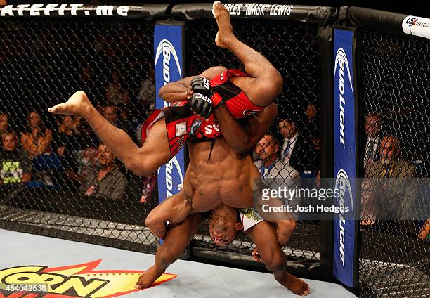 Neil Magny lifts Alex Garcia of the Dominican Republic and prepares to slam him in their welterweight fight during the UFC Fight Night event at the...