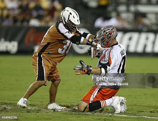 Midfielder John Ortolani of the Rochester Rattlers pushes midfielder Anthony Kelly of the Denver Outlaws during the 2014 Major League Lacrosse...