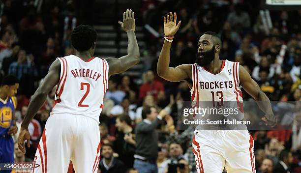 James Harden and Patrick Beverley of the Houston Rockets react to a three-point shot late in the fourth quarter during the game against the Golden...