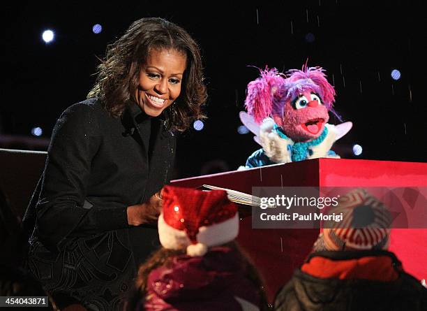 First lady Michelle Obama reads "The Night Before Christmas" along with muppet Abby Cadabby to children on stage during the the National Christmas...