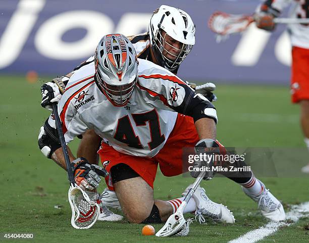 Midfielder John Ortolani of the Rochester Rattlers battles midfielder Anthony Kelly of the Denver Outlaws at midfield during the 2014 Major League...