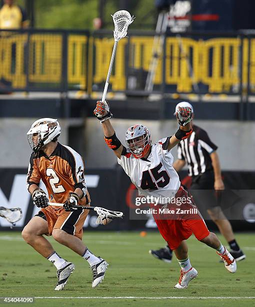 Midfielder Dominic Sebastini of the Denver Outlaws dives towards midfielder John Lawson of the Rochester Rattlers during the 2014 Major League...