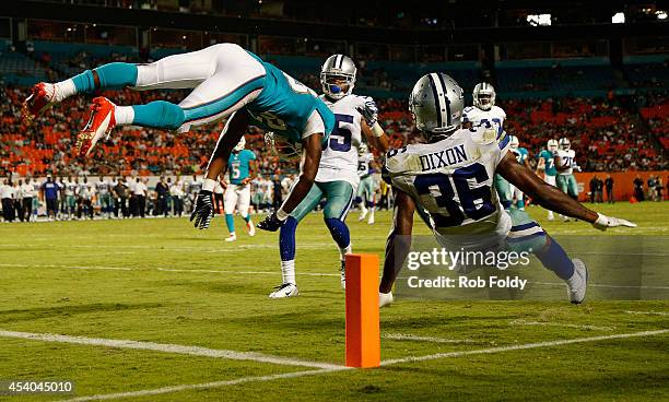 Matt Hazel of the Miami Dolphins is upended with Ahmad Dixon of the Dallas Cowboys on an imcomplete pass in the fourth quarter during a preseason...