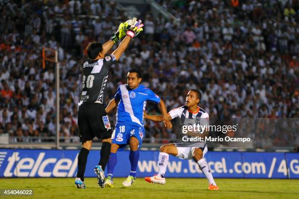 Alonso Hernandez of Monterrey observes as Rodolfo Cota, goalkeeper of Puebla, holds the ball during a match between Monterrey and Puebla as part of...