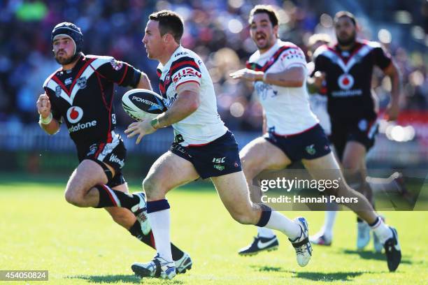 James Maloney of the Roosters makes a break during the round 24 NRL match between the New Zealand Warriors and the Sydney Roosters at Mt Smart...