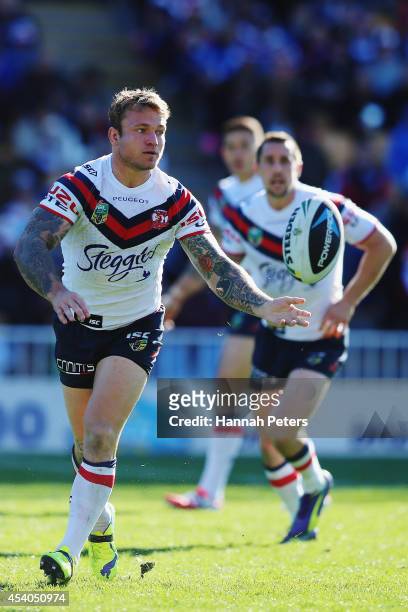 Jake Friend of the Roosters passes the ball out during the round 24 NRL match between the New Zealand Warriors and the Sydney Roosters at Mt Smart...