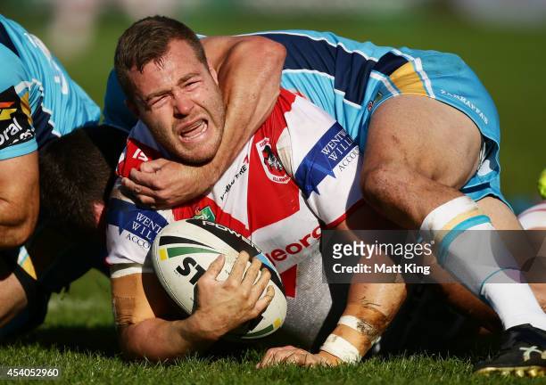 Trent Merrin of the Dragons is tackled during the round 24 NRL match between the St George Illawarra Dragons and the Gold Coast Titans at WIN Jubilee...