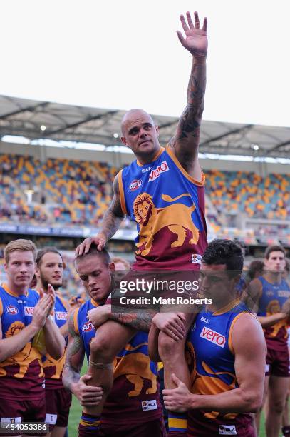 Ashley McGrath of the Lions is chaired off the field after the round 22 AFL match between the Brisbane Lions and the Fremantle Dockers at The Gabba...
