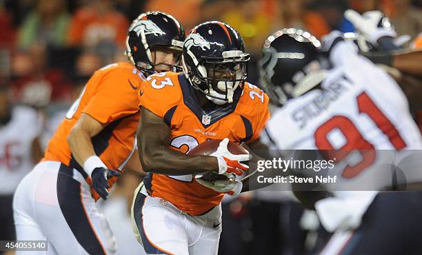 Denver Broncos running back Ronnie Hillman takes a handoff from Peyton Manning in the first quarter of a preseason football game against the Houston...