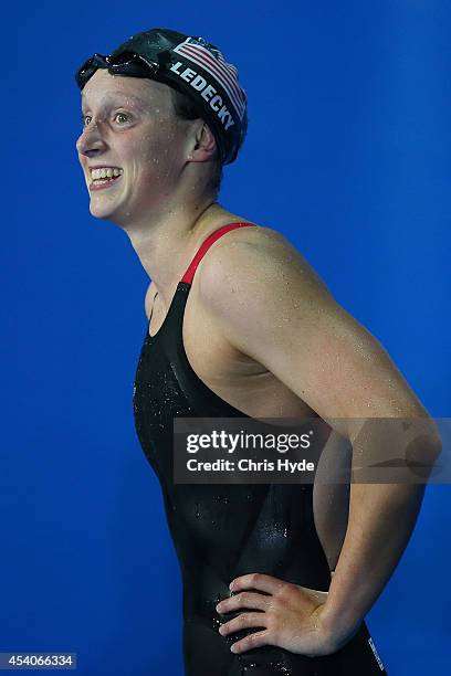 Katie Ledecky of the USA celebrates after winning and breaking a world record in the Women's 1500m Freestyle Final during day four of the 2014 Pan...