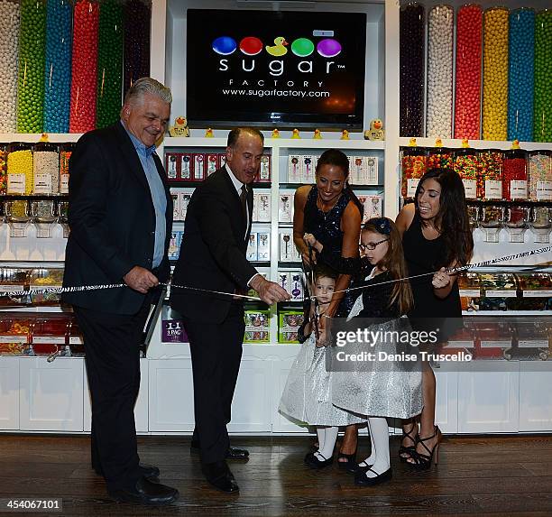 Steve Sisolak, Tom Racine, Charissa, Gracie, Brooklyn and Veronica Davidiovici during the Sugar Factory grand opening at Town Square on December 6,...