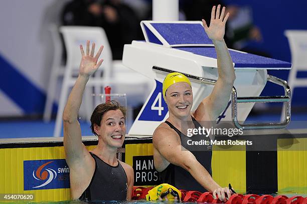 Cate Campbell of Australia celebrates winning the Women's 50m Freestyle Final with Bronte Campbell of Australia during day four of the 2014 Pan...