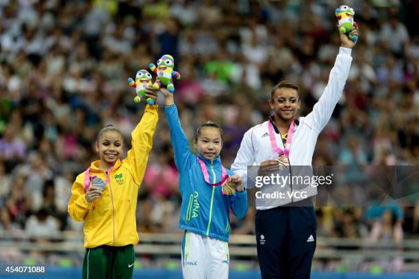 Silver medalist Flavia Lopes Saraiva of Brazil, Gold medalist Wang Yan of China and Bronze medalist Elissa Downie of Great Britain celebrate on the...
