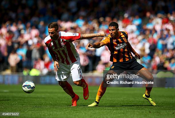 Marko Arnautovic of Stoke City holds off Jake Livermore of Hull City during the Barclays Premier League match between Hull City and Stoke City at KC...