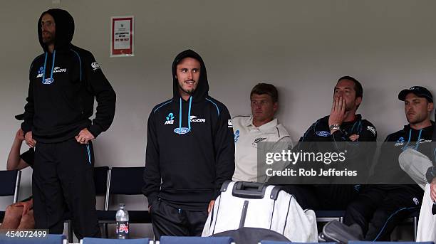 Dejected New Zealand players Aaron Redmond, Hamish Rutherford, Corey Anderson and Brendon McCullum look on as rain continues, forcing a draw after...