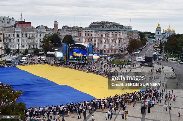 People hold a the biggest world Ukrainian flag during celebration of Ukrainian Independence Day in Kiev on August 24, 2014. Ukraine's President Petro...