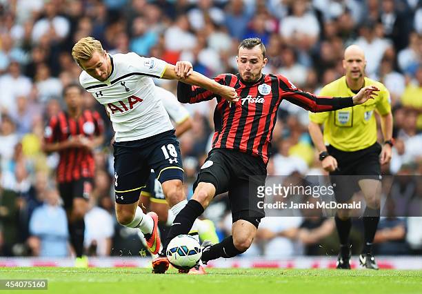 Harry Kane of Spurs is challenged by Jordon Mutch of QPR during the Barclays Premier League match between Tottenham Hotspur and Queens Park Rangers...